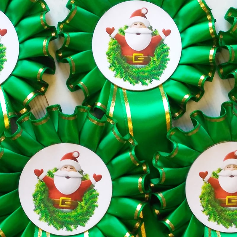 Green rosettes with a gold border showing a santa logo